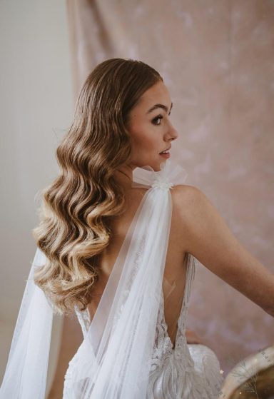 Defined glamour waves on model with bronde hair.